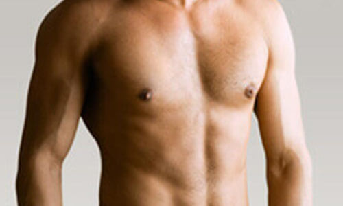 Close-up picture of a man,  happy with his male breast reduction  procedure he had in San José, Costa Rica.  The man is shown  standing,  to feature his male breast reduction.